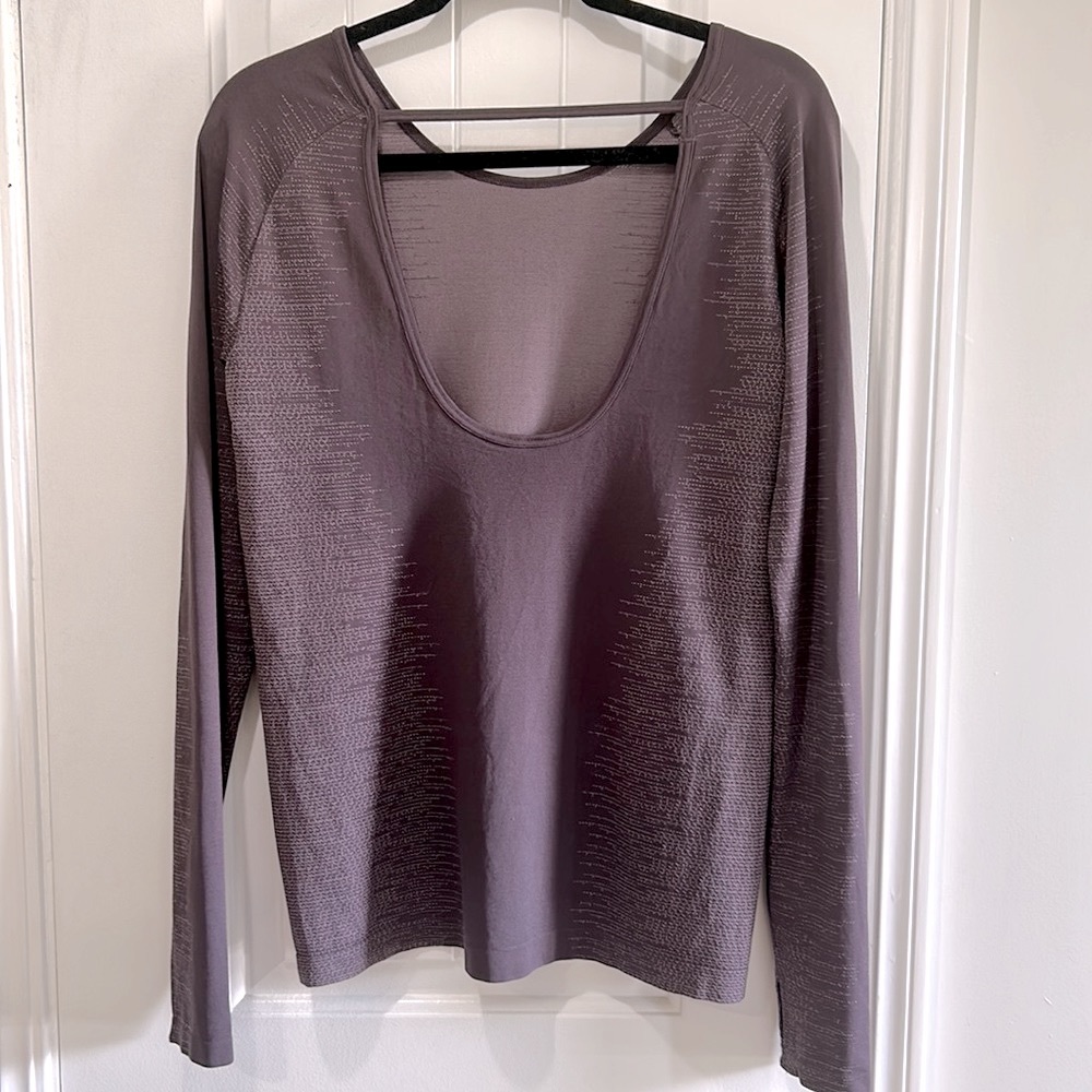 Under Armour Purple long sleeve fitted longer shirt with open back. NWOT
